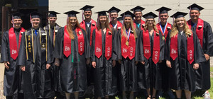 Class of 2019 standing outside the MS/HS building in the caps & gowns