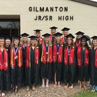 Class of 2017 standing outside the MS/HS building in their caps & gowns